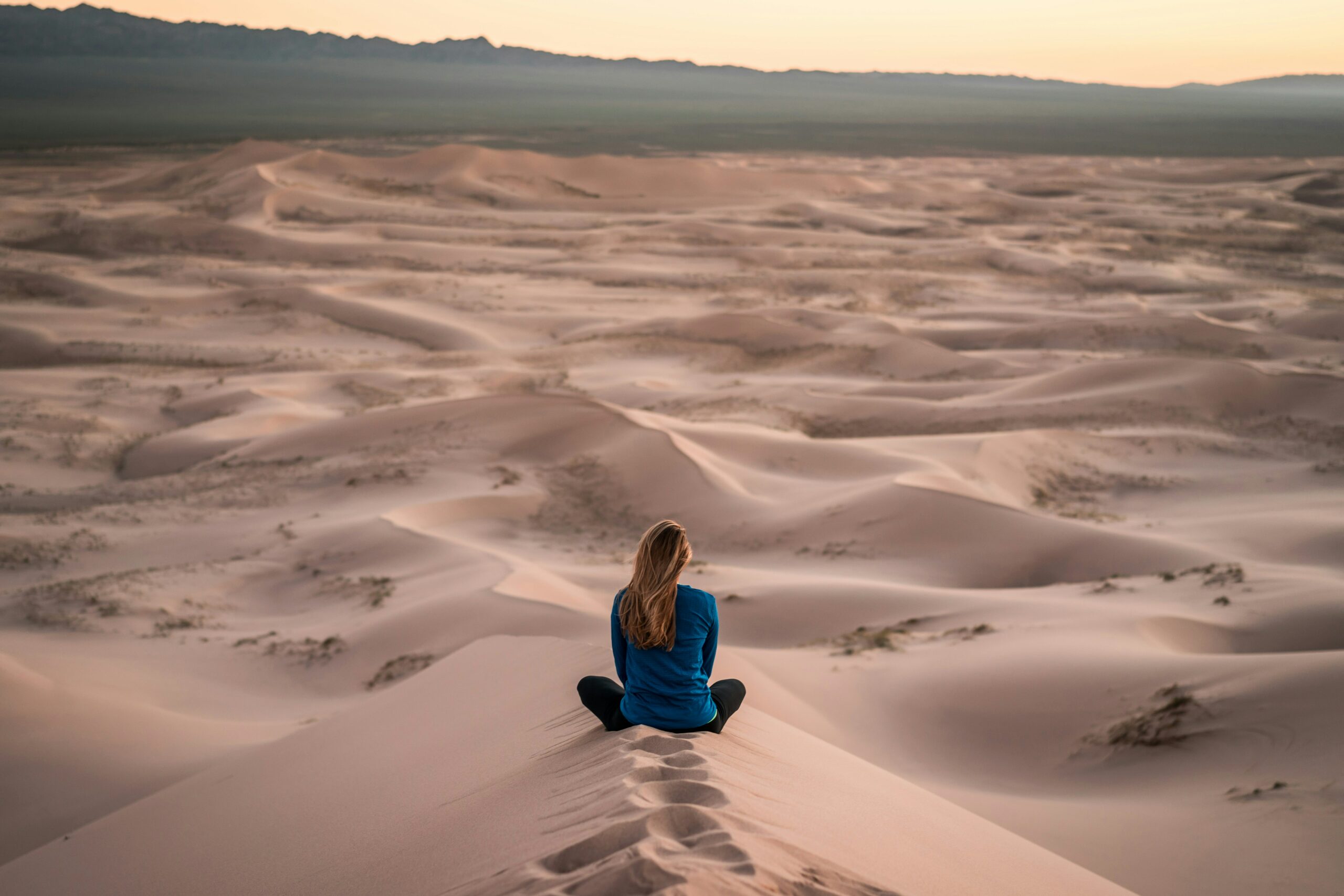 woman meditating in the desert for meditation and mindfulness